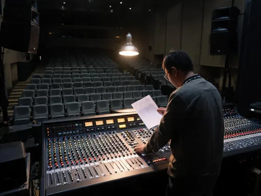 Venue staff checking audio preset notes