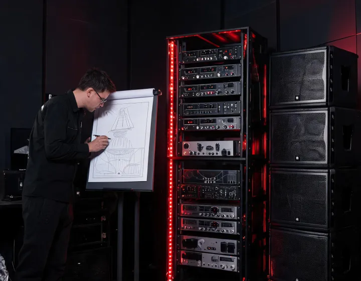 Audio engineer reviewing Martin Audio venue design